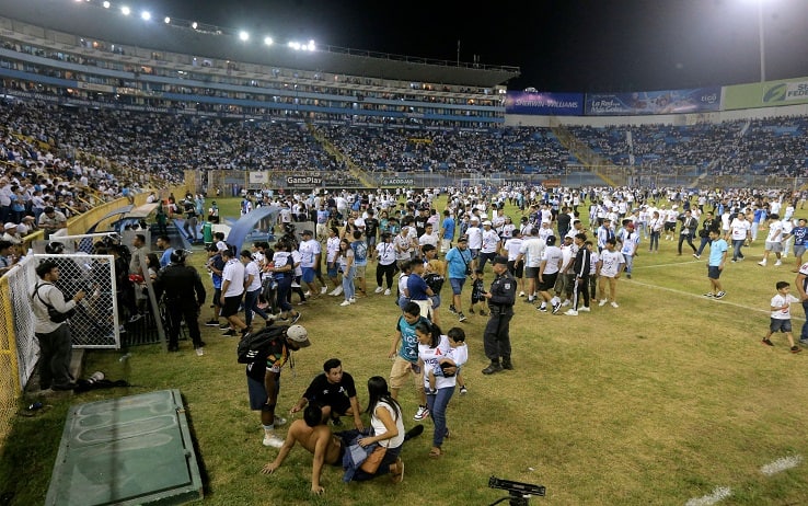 Supporters are helped by others following a stampede during a football match between Alianza and FAS at Cuscatlan stadium in San Salvador, on May 20, 2023. Nine people were killed May 20, 2023 in a stampede at an El Salvador stadium where soccer fans had gathered to watch a local tournament, police said. (Photo by Milton FLORES / AFP) (Photo by MILTON FLORES/AFP via Getty Images)