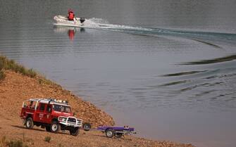 Portuguese firefighters work onboard a boat during a new search operation amid the investigation into the disappearance of Madeleine McCann (Maddie) in the Arade dam, in Silves, near Praia da Luz, on 23 May, 2023. This operation stems from a European Investigation Order addressed by the German authorities to Portugal and focuses on the Arade dam, located about 50 kilometers from Praia da Luz, the place where the child disappeared in May 2007, 16 years ago, while on vacation with her parents.  (Photo by FILIPE AMORIM / AFP) (Photo by FILIPE AMORIM/AFP via Getty Images)
