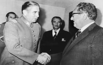 Chilean President Augusto Pinochet greets Secretary of State Harry Kissinger on his arrival at the President's office. Kissinger took up the issue of the Human Rights Commission which has raised objections to Chilean abuses of civil liberties, but stopped short of taking any direct American action against Chile in the Organization of American States meeting here.