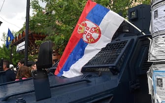 epa10661631 A Serbian flag is placed by protesters on a Kosovo special police vehicle in front of the building of the municipality in Zvecan, Kosovo, 29 May 2023. At least ten people were injured in violence between Kosovo police and ethnic Serbs in the town of Zvecan on 26 May, after protesters gathered outside state buildings while Albanian mayors were heading to assume office.  EPA/GEORGI LICOVSKI