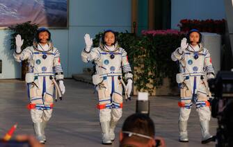 epa10662663 (L-R) Payload expert Gui Haichao, space flight engineer Zhu Yangzhu, and commander Jing Haipeng wave during the seeing-off ceremony before boarding for the launch of the Long March-2F carrier rocket with a Shenzhou-16 manned space flight at the Jiuquan Satellite Launch Centre, in Jiuquan, Gansu province, China, 30 May 2023. The Shenzhou-16 manned space flight mission will transport three Chinese astronauts to the Tiangong space station.  EPA/ALEX PLAVEVSKI