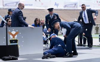 TOPSHOT - US President Joe Biden is helped up after falling during the graduation ceremony at the United States Air Force Academy, just north of Colorado Springs in El Paso County, Colorado, on June 1, 2023. (Photo by Brendan Smialowski / AFP) (Photo by BRENDAN SMIALOWSKI/AFP via Getty Images)