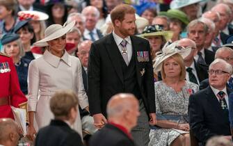TOPSHOT - Britain's Prince Harry, Duke of Sussex (C) and Britain's Meghan, Duchess of Sussex (centre left) attend the National Service of Thanksgiving for The Queen's reign at Saint Paul's Cathedral in London on June 3, 2022 as part of Queen Elizabeth II's platinum jubilee celebrations. - Queen Elizabeth II kicked off the first of four days of celebrations marking her record-breaking 70 years on the throne, to cheering crowds of tens of thousands of people. But the 96-year-old sovereign's appearance at the Platinum Jubilee -- a milestone never previously reached by a British monarch -- took its toll, forcing her to pull out of a planned church service. (Photo by ARTHUR EDWARDS / POOL / AFP) (Photo by ARTHUR EDWARDS/POOL/AFP via Getty Images)