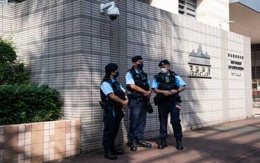 epa10630483 Police stand guard outside the West Kowloon Magistrates  Court on the first day of the trial of the Chairperson of the Hong Kong Journalists Association (HKJA) Ronson Chan in Hong Kong, China, 16 May 2023. Chan was charged with obstructing police officers while reporting on a residence meeting in a housing estate in September 2022. He was granted bail subsequently and allowed to hold on to his passport, and also permitted to travel to the UK for a journalism fellowship.  EPA/Bertha WANG
