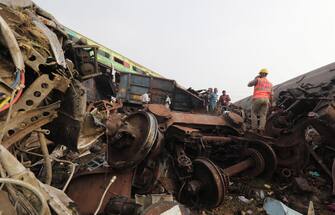 epa10669875 Damaged train coaches are piled up as the National Disaster Response Force Rescue continues work at the site of a train accident at Odisha Balasore, India, 03 June 2023. Over 200 people died and more than 900 were injured after three trains collided one after another. According to railway officials the Coromandel Express, which operates between Kolkata and Chennai, crashed into the Howrah Superfast Express.  EPA/PIYAL ADHIKARY