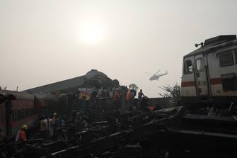 epa10669874 A helicoter flys over the site as the National Disaster Response Force Rescue continues work at the site of a train accident at Odisha Balasore, India, 03 June 2023. Over 200 people died and more than 900 were injured after three trains collided one after another. According to railway officials the Coromandel Express, which operates between Kolkata and Chennai, crashed into the Howrah Superfast Express.  EPA/PIYAL ADHIKARY