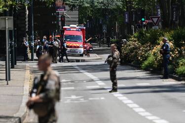 French police officers stand next to an emergency truck in Annecy, central-eastern France on June 8, 2023, following a mass stabbing in the French Alpine town. Seven people, including six children, have been injured in a mass stabbing in the town of Annecy in the French Alps, security sources told AFP. A man armed with a knife attacked a group of children aged around three years old as they played in a park near the lake in the town at around 9:45 am (0745 GMT), a security source who asked not to be named and a local official told AFP. (Photo by OLIVIER CHASSIGNOLE / AFP) (Photo by OLIVIER CHASSIGNOLE/AFP via Getty Images)