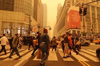 NEW YORK, NY - JUNE 7: People cross 34th Street in Herald Square as heavy smoke fills the air on June 7, 2023, in New York City.  (Photo by Gary Hershorn/Getty Images)