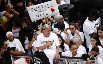 epa10717501 Nahel's mother (C), wearing a 'Justice for Nahel' T-shirt, reacts as she attends a march in the memory of her 17-year-old son who was killed by French Police in Nanterre, near Paris, France, 29 June 2023. Violence broke out after the police fatally shot a 17-year-old during a traffic stop in Nanterre on 27 June. According to the French interior minister, 31 people were arrested with 2,000 officers being deployed to prevent further violence. EPA/YOAN VALAT