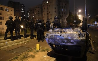epa10718278 Riot police patrol an area during clashes with protesters in Nanterre, near Paris, France, 29 June 2023. Violence broke out after police fatally shot a 17-year-old during a traffic stop in Nanterre on 27 June 2023. According to the French interior minister, 31 people were arrested with 2,000 officers being deployed to prevent further violence.  EPA/JULIEN MATTIA
