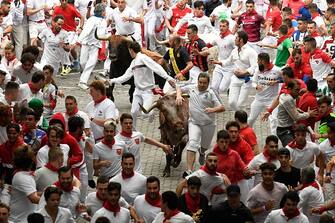 Participants run ahead of bulls during the first 
