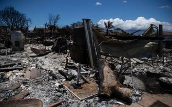 epa10802253 A house is in ruins after being destroyed by the Lahaina Fire in Lahaina, Hawaii, USA, 15 August 2023. At least 99 people were killed in the Lahaina wildfire that burnt in Maui, which is considered the largest natural disaster in Hawaii's state history .  EPA/ETIENNE LAURENT