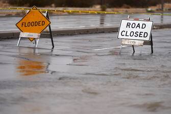 epa10811207 Signs are put in place to close a road due to flooding as Tropical Storm Hilary arrives in Cathedral City, California, USA, 20 August 2023. Southern California is under a tropical storm warning for the first time in history as Hilary makes landfall.  The last time a tropical storm made landfall in Southern California was September 15, 1939, according to the National Weather Service.  EPA/ALLISON DINNER