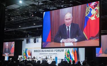 epa10813801 President of Russia Vladimir Putin appears on a monitor as he delivers a recorded speech off location during the 15th BRICS Summit in Johannesburg, South Africa, 22 August 2023. South Africa is hosting the 15th BRICS Summit, (Brazil, Russia, India, China and South Africa), as the group s economies account for a quarter of global gross domestic product. Dozens of leaders of other countries in Africa, Asia and the Middle East are also attending the summit.  EPA/KIM LUDBROOK