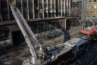 TOPSHOT - Firefighters work at the scene of a fire in Johannesburg on August 31, 2023. At least 20 people have died and more than 40 were injured in a fire that engulfed a five-storey building in central Johannesburg on August 31, 2023, the South African city's emergency services said.  (Photo by Michele Spatari / AFP) (Photo by MICHELE SPATARI/AFP via Getty Images)