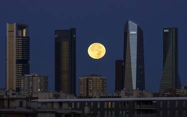 A blue supermoon sets beyond skyscraper office buildings in the Cuatro Torres business district in Madrid, Spain, on Thursday, Aug. 31, 2023. Spanish inflation quickened again in the first of a string of reports from around the region that will help European Central Bank officials judge whether to keep raising interest rates. Photographer: Paul Hanna/Bloomberg via Getty Images