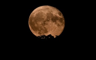 TURIN, ITALY - AUGUST 2:The Sturgeon Super Moon is seen on August 2, 2023 in Turin, Italy.  This is the first of two super moons in the month of August, with the end of the month seeing a rare super blue moon, which happens about once every ten years.  (Photo by Stefano Guidi/Getty Images)