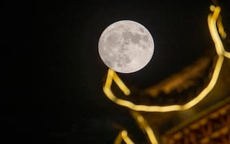 CONGJIANG, CHINA - AUGUST 30, 2023 - Photo taken on Aug 30, 2023 shows the supermoon over Gulou Ecological Square in Congjiang county, Southwest China's Guizhou province.  (Photo by Costfoto/NurPhoto via Getty Images)