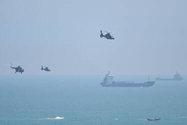 TOPSHOT - Chinese military helicopters fly past Pingtan island, one of mainland China's closest point from Taiwan, in Fujian province on August 4, 2022, ahead of massive military drills off Taiwan following US House Speaker Nancy Pelosi's visit to the self-ruled island. - China is due on August 4 to kick off its largest-ever military exercises encircling Taiwan, in a show of force straddling vital international shipping lanes following a visit to the self-ruled island by US House Speaker Nancy Pelosi. (Photo by Hector RETAMAL / AFP) (Photo by HECTOR RETAMAL/AFP via Getty Images)