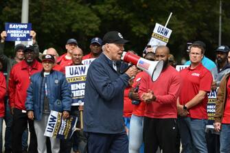 US President Joe Biden addresses striking members of the United Auto Workers (UAW) union at a picket line outside a General Motors Service Parts Operations plant in Belleville, Michigan, on September 26, 2023. Some 5,600 members of the UAW walked out of 38 US parts and distribution centers at General Motors and Stellantis at noon September 22, 2023, adding to last week's dramatic worker walkout.  According to the White House, Biden is the first sitting president to join a picket line.  (Photo by Jim WATSON / AFP) (Photo by JIM WATSON/AFP via Getty Images)