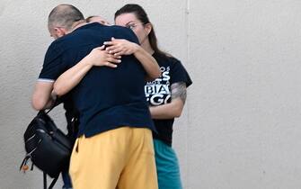 Relatives and friends of the victims killed in a fire at a nightclub in Murcia, react outside the city's Sports Pavillion where they have received psychological assistance on October 1, 2023. At least 13 people were killed in a fire in a Spanish nightclub today morning, authorities said, with fears the toll could still rise as rescue workers sift through the debris. The fire appears to have broken out in a building housing the "Teatre" and "Fonda Milagros" clubs in the city of Murcia in southeastern Spain in the early morning hours. (Photo by JOSE JORDAN / AFP) (Photo by JOSE JORDAN/AFP via Getty Images)