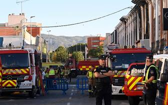 Emergency services cordon off a street where at least thirteen people were killed in a fire at a nightclub in Murcia, on October 1, 2023. At least 13 people were killed in a fire in a Spanish nightclub today morning, authorities said, with fears the toll could still rise as rescue workers sift through the debris. The fire appears to have broken out in a building housing the "Teatre" and "Fonda Milagros" clubs in the city of Murcia in southeastern Spain in the early morning hours. (Photo by JOSE JORDAN / AFP) (Photo by JOSE JORDAN/AFP via Getty Images)