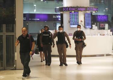 epa10896928 Police officers patrol inside the Siam Paragon shopping mall after the premises were evacuated following gunshots, in Bangkok, Thailand, 03 October 2023. Thai police said the suspected gunman was arrested, while emergency services confirmed at least three people were killed.  EPA/RUNGROJ YONGRIT