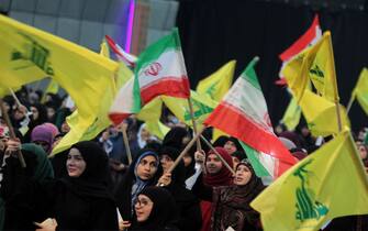 06 February 2019, Lebanon, Beirut: Supporters of Hezbollah, the pro-Iranian Lebanese Islamist political party and militant group, wave flags of Iran and Hezbollah during a rally to mark the 40th anniversary of the Iranian Islamic Revolution which toppled Mohammad Reza Pahlavi, the last Shah of Iran.  Photo: Marwan Naamani/dpa