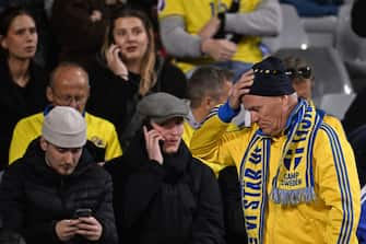 Swedish supporters react as they wait in the stand during the Euro 2024 qualifying football match between Belgium and Sweden at the King Baudouin Stadium in Brussels on October 16, 2023, after an 'attack' that targeted Swedish citizens in a street of Brussels.  Belgian federal prosecutor leading on terrorism cases launched an investigation into an attack that left two dead in Brussels on October 16, 2023 evening, a spokesperson told AFP.  Belgium PM slams Brussels 'attack' targeting Swedish citizens.  (Photo by JOHN THYS / AFP) (Photo by JOHN THYS/AFP via Getty Images)