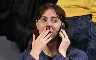 A supporter makes phone call as she waits in the stand during the Euro 2024 qualifying football match between Belgium and Sweden at the King Baudouin Stadium in Brussels on October 16, 2023, after an 'attack' that targeted Swedish citizens in a street of Brussels.  Belgian federal prosecutor leading on terrorism cases launched an investigation into an attack that left two dead in Brussels on October 16, 2023 evening, a spokesperson told AFP.  Belgium PM slams Brussels 'attack' targeting Swedish citizens.  (Photo by JOHN THYS / AFP) (Photo by JOHN THYS/AFP via Getty Images)