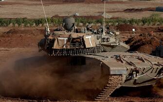 epa10940557 An Israeli Merkava tank during maneuvers at an undisclosed location along the border with Lebanon, in Israel, 26 October 2023. Tensions remain high at the border between Israel and Lebanon after the Israeli-Palestinian conflict escalated following an unprecedented attack carried out by Hamas militants from Gaza into Israel on 07 October 2023. EPA/ATEF SAFADI