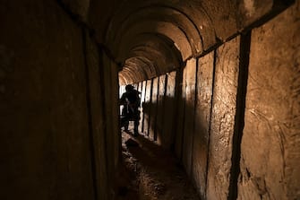 TOPSHOT - A member of the Palestinian Islamic Jihad militant group walks in a tunnel in the Gaza strip, on April 17, 2022, during a media tour amid escalating violence with Israel.  - More than 20 Palestinians and Israelis were wounded in several incidents in and around Jerusalem's flashpoint Al-Aqsa Mosque complex, two days after major violence at the site.  (Photo by Mahmud HAMS / AFP) (Photo by MAHMUD HAMS/AFP via Getty Images)