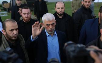 Yahia al-Sinwar (R), Gaza Strip chief of the Palestinian Islamist Hamas movement, greets a supporter as he arrives to attend a rally marking Al-Quds (Jerusalem) Day, a commemorative day in support of the Palestinian people celebrated annually on the last Friday of the Muslim fasting month of Ramadan by an initiative started by the late founder of the Islamic republic in Iran.  Gaza City.  Palestine.
