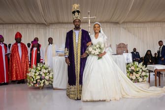 TOPSHOT - The Kyabazinga (King) of the Busoga Kingdom William Gabula Nadiope IV and the Inhebantu (Queen) Jovia Mutesi stand in the altar during their royal wedding at the Christ's Cathedral Bugembe in Jinja on November 18, 2023. (Photo by BADRU KATUMBA / AFP) (Photo by BADRU KATUMBA/AFP via Getty Images)