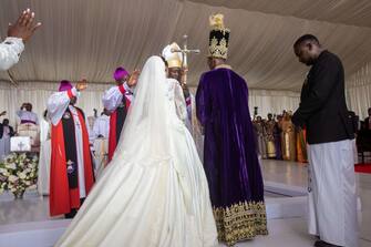 The Kyabazinga (King) of the Busoga Kingdom William Gabula Nadiope IV and the Inhebantu (Queen) Jovia Mutesi pray in front of a priest during their royal wedding at the Christ's Cathedral Bugembe in Jinja on November 18, 2023. (Photo by BADRU KATUMBA / AFP) (Photo by BADRU KATUMBA/AFP via Getty Images)