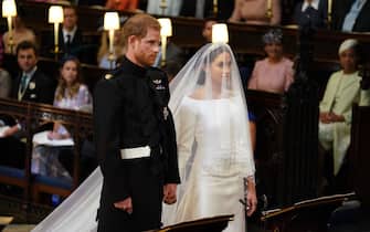 WINDSOR, UNITED KINGDOM - MAY 19:  Prince Harry and Meghan Markle stand together in St George's Chapel at Windsor Castle for their wedding on May 19, 2018 in Windsor, England. (Photo by Dominic Lipinski - WPA Pool/Getty Images)
