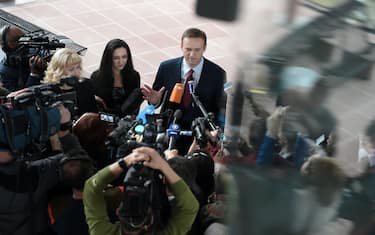 Russian opposition leader Alexei Navalny (C) answers to journalists ahead of a hearing at the European Court of Human Rights (ECHR) in Strasbourg on November 15, 2018. - ?Top Kremlin critic Alexei Navalny heads on November 15 to the European Court of Human Rights which will rule on whether his repeated arrests were politically motivated. The court in Strasbourg must decide whether Navalny, an anti-corruption campaigner and President Vladimir Putin's most vocal critic, was arbitrarily arrested and detained by Russian authorities. Between 2012 and 2014 he was arrested seven times at public gatherings and prosecuted for either breaching procedures for holding public events or disobeying a police order. (Photo by Frederick FLORIN / AFP)        (Photo credit should read FREDERICK FLORIN/AFP via Getty Images)