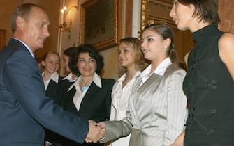 MOSCOW, RUSSIA - OCTOBER 6, 2003:  Russian President Vladimir Putin (L) congratulated on Monday Russian girls -the winners of the World Championship in rhythmic gymnastics and the "Kremlin Cup" tennis tournament. . Pictured right to left - are Anastasia Myskina (tennis). Alina Kabayeva (gymnastics) , Irina Chashchina (gymnastics) , chief coach of the Russian Gymnastics team Irina Viner, and Vera Sesina (gymnastics). (Photo by TASS via Getty Images)