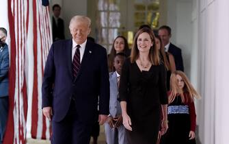 US President Donald Trump (L) and Judge Amy Coney Barrett (R), arrive at the Rose Garden of the White House in Washington, DC, on September 26, 2020. - Judge Amy Coney Barrett, who was nominated Saturday to the US Supreme Court, is a darling of conservatives for her religious views but detractors warn her confirmation would shift the nation's top court firmly to the right. (Photo by Olivier DOULIERY / AFP) (Photo by OLIVIER DOULIERY/AFP via Getty Images)
