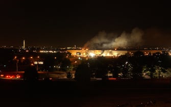 394422 03: Smoke and flames rise over the Pentagon late into the night September 11, 2001 following a suspected terrorist crash of a hijacked commercial airliner into the Pentagon in Arlington, VA. The attack came at approximately 9:40 a.m. as the plane, originating from Washington D.C.''s Dulles airport, was flown into the southern side of the building. (Photo byBob Houlihan/U.S. Navy/Getty Images)