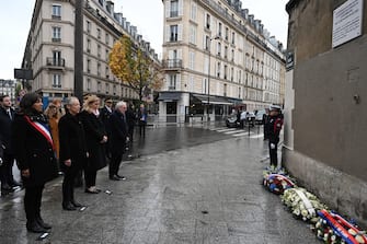 epa10972874 Mayor of Paris Anne Hidalgo (L), French Prime Minister Elisabeth Borne (2-L) and President of the French National Assembly Yael Braun-Pivet (3-L) stand in front of a commemorative plaque to mark the eighth anniversary of the Paris attacks of 13 November 2015, near the 'Petit Cambodge' and 'Carillon' bar and restaurants in Paris, 13 November 2023. On 13 November 2015, gunmen killed 130 people in a terrorist attack across Parisian cafes, the Stade de France stadium and the Eagles of Death Metal concert at the Bataclan concert hall.  EPA/BERTRAND GUAY / POOL  MAXPPP OUT