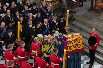 LONDON, ENGLAND - SEPTEMBER 19: The bearer party with the coffin of Queen Elizabeth II as it is taken from Westminster Abbey during the state funeral and burial of Queen Elizabeth II at Westminster Abbey on September 19, 2022 in London, England. Members of the public are able to pay respects to Her Majesty Queen Elizabeth II for 23 hours a day from 17:00 on September 18, 2022 until 06:30 on September 19, 2022. Queen Elizabeth II died at Balmoral Castle in Scotland on September 8, 2022, and is succeeded by her eldest son, King Charles III. (Photo by Gareth Fuller- WPA Pool/Getty Images)