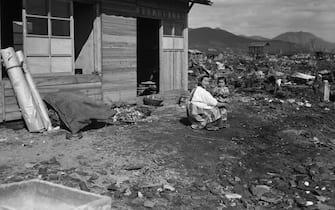 (Original Caption) 03/11/46-Hiroshima, Japan: The Japanese city of Hiroshima, all but obliterated just seven months ago by an "atomic" bomb, is now the scene of a housing project to provide shelter for the unfortunate citizens there. This photo taken in the heart of the district where the atomic bomb struck, shows one of the housing units (there 600 units) arising from the rubble of what was once war factories. Photo by Howard Robbins INP staff photographer in Japan
