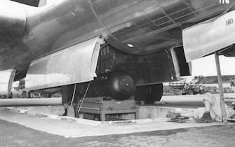 View of the atomic bomb, codenamed 'Little Boy,' as it is hoisted into the bomb bay of the B-29 Superfortress 'Enola Gay' on the North Field of Tinian airbase, North Marianas Islands, early August, 1945. The bomb was dropped on the Japanese city of Hiroshima on August 6. (Photo by PhotoQuest/Getty Images)