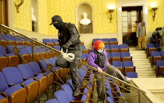 1294932405 WASHINGTON, DC - JANUARY 06: Protesters enter the Senate Chamber on January 06, 2021 in Washington, DC. Congress held a joint session today to ratify President-elect Joe Biden's 306-232 Electoral College win over President Donald Trump. Pro-Trump protesters have entered the U.S. Capitol building after mass demonstrations in the nation's capital. (Photo by Win McNamee/Getty Images)