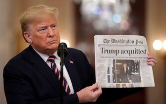 WASHINGTON, DC - FEBRUARY 06:  U.S. President Donald Trump holds a copy of The Washington Post as he speaks in the East Room of the White House one day after the U.S. Senate acquitted on two articles of impeachment, ion February 6, 2020 in Washington, DC. After five months of congressional hearings and investigations about President Trump’s dealings with Ukraine, the U.S. Senate formally acquitted the president on Wednesday of charges that he abused his power and obstructed Congress. (Photo by Drew Angerer/Getty Images)