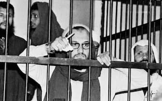 EGYPT 1982:  (FILE PHOTO)  Ayman Al-Zawahri stands behind bars in an Egyptian court in 1982 during his trial as one of the masterminds behind the assassination of Egyptian president Anwar Sadat in 1981. Al-Zawahri, an Egyptian surgeon, became a member of Egyptian Islamic Jihad in 1981. After three years in jail, convicted of being a member of an illegal Islamic group, Al-Zawahri was expelled from the country.  He travelled to Pakistan, where he met Osama bin Laden. He is now considered to be bin Laden's top lieutenant.  (Photo by Getty Images)