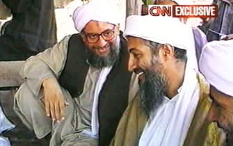 AFGHANISTAN - MAY 26: (JAPAN OUT)(VIDEO CAPTURE) This image taken from a collection of videotapes obtained by CNN, shows members of the upper echelon of the terrorist group al Qaeda; Ayman al-Zawahiri the second in command (L) and Osama Bin Laden the leader (R) after a press conference on May 26, 1998 in Afghanistan. The tape showing this image was included in a large collection of videotapes obtained by CNN from a secret location in Afghanistan. Although it can not be positively verified that the tapes were created by the al Qaeda terrorist network the tapes do show dramatic and sometimes repulsive images of poison gas experiments on dogs, instructions on making TNT and weapons training by men speaking Arabic. (Photo by CNN via Getty Images)