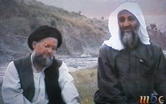 UNSPECIFIED:This frame grab from the Saudi-owned television network MBC (Middle East Broadcasting Center) shows alleged terror mastermind Osama bin Laden sitting next to his Egyptian lieutenant Ayman al-Zawahri in an undated videotape broadcast by the Dubai-based MBC 17 April 2002. Bin laden hailed the economic losses suffered by the United States as a result of the September 11 suicide attacks on Washington and New York in the tape which was reportedly recorded in December. "God ordered us to terrorize the infidels, and we terrorized the infidels," the spokesman of Bin Laden's al-Qaeda network Suleiman Abu Ghaith said in the same tape, claiming the group's responsibility for the suicide attacks.  AFP PHOTO/MBC (Photo credit should read AFP via Getty Images)