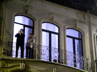 BRUSSELS, BELGIUM - MARCH 20: People applaud doctors and nurses from their balcony on March 20, 2020, in Brussels, Belgium. The Belgian government have imposed a strict lockdown to stop the spread of the novel coronavirus (COVID-19). (Photo by Thierry Monasse/Getty Images)